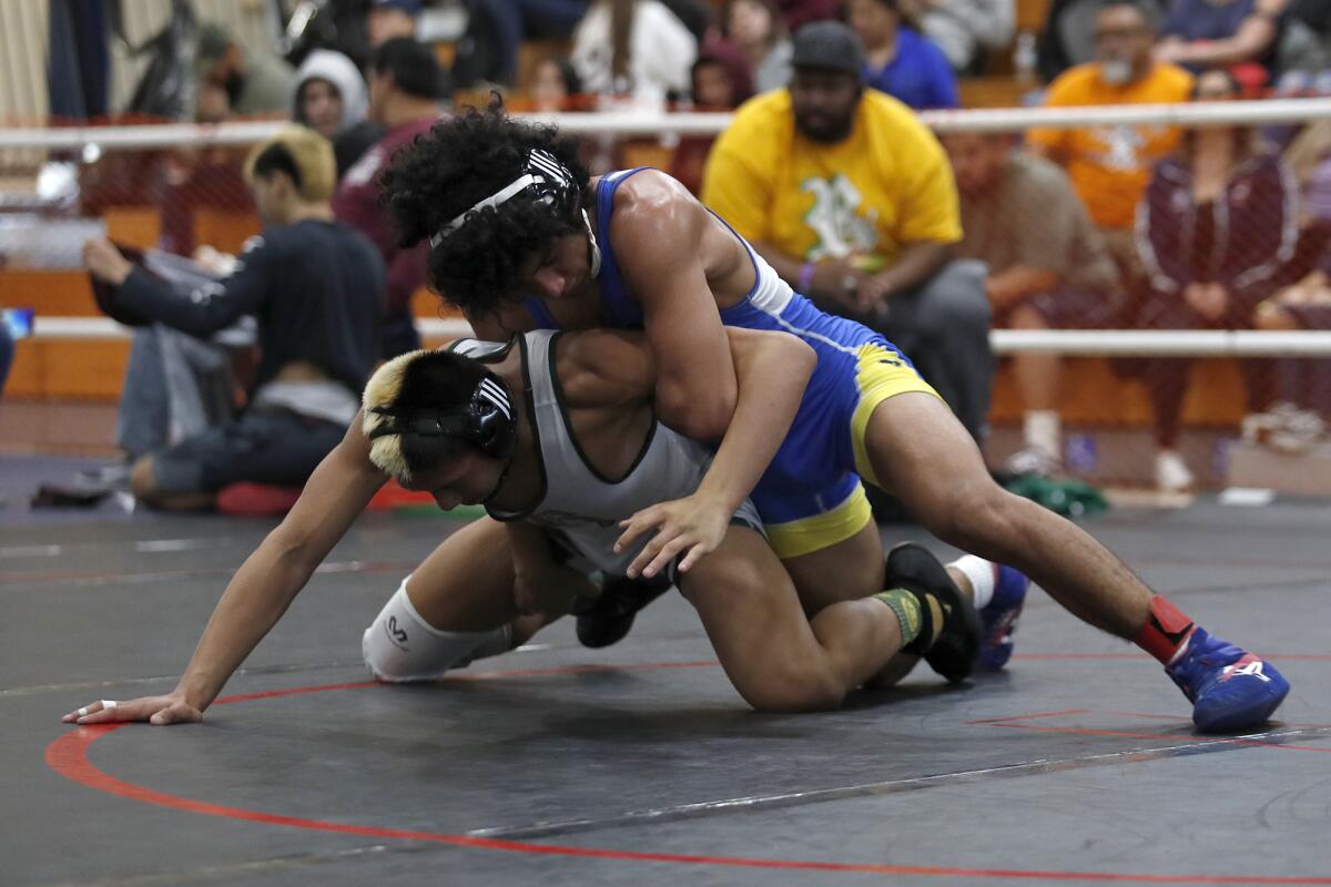 Fountain Valley's Luis Ramirez, top, pictured competing on Feb. 15 in the CIF Southern Section Northern Division individual championships, helped the Barons move into fourth place in the Masters Meet on Friday.