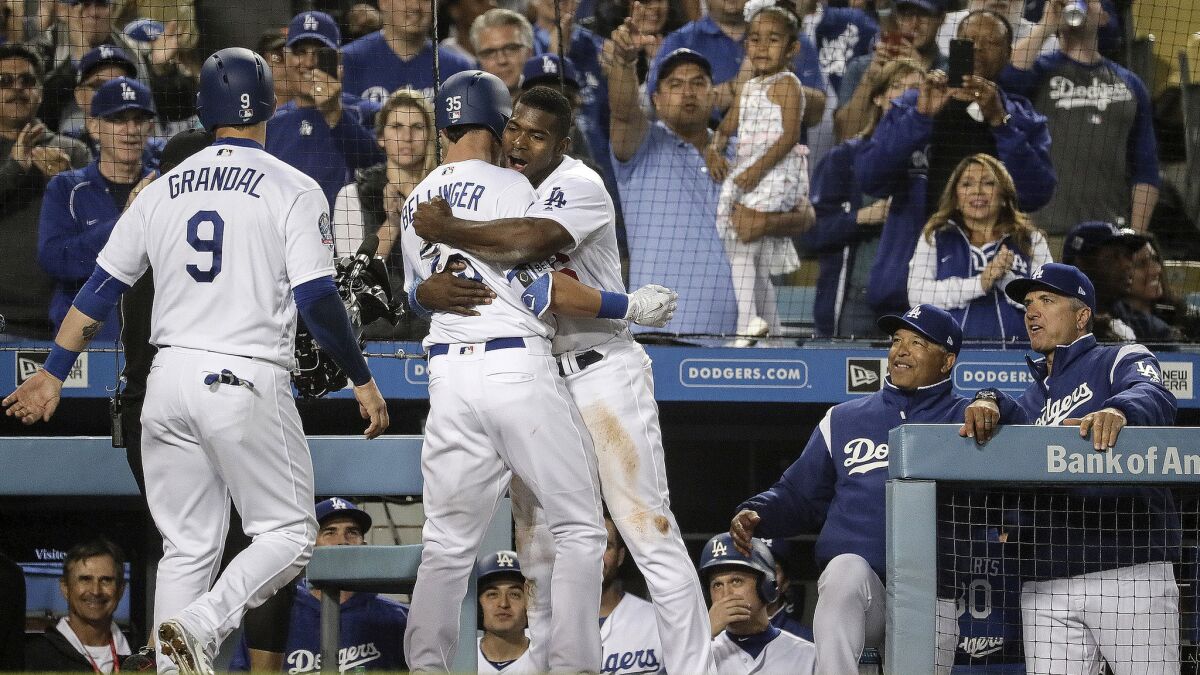 Yasiel Puig embraces Dodgers teammate Cody Bellinger after the first baseman homered in the sixth inning off Giants reliever Josh Osich.