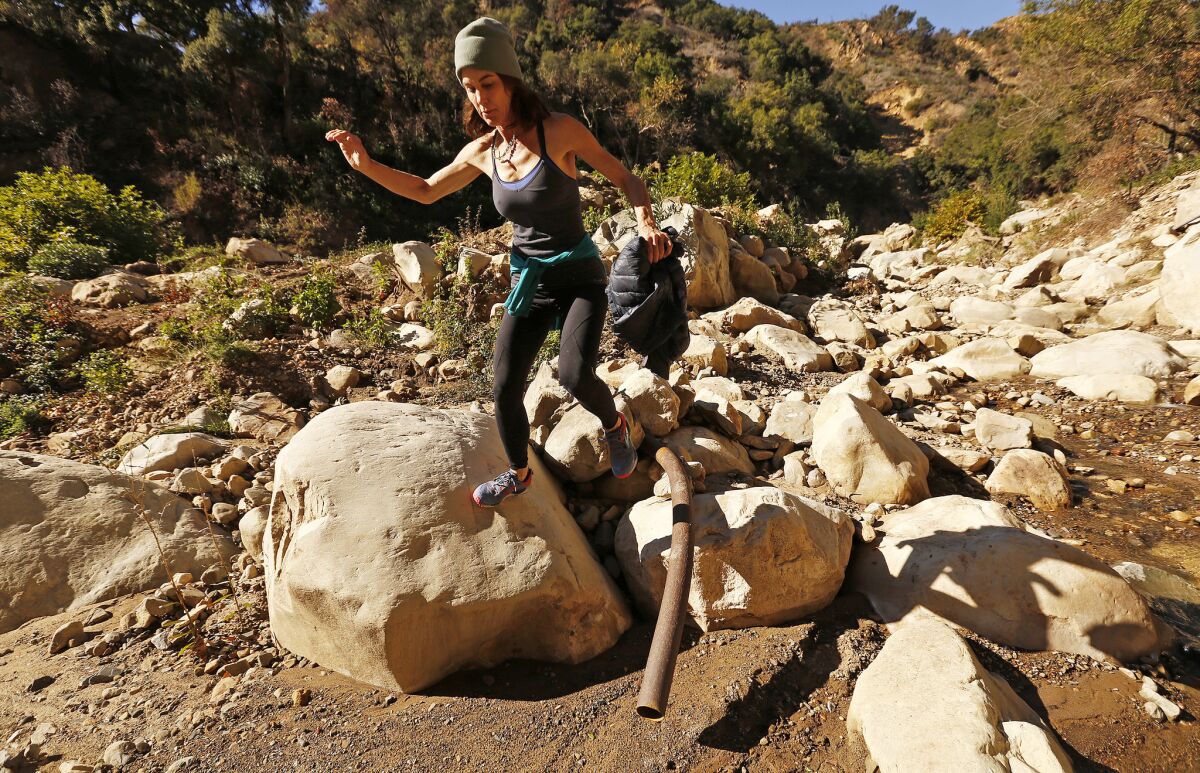 Alison Hardy hikes among the boulders exposed at the Cold Spring Creek December 4, 2018. (Al Seib / Los Angeles Times)