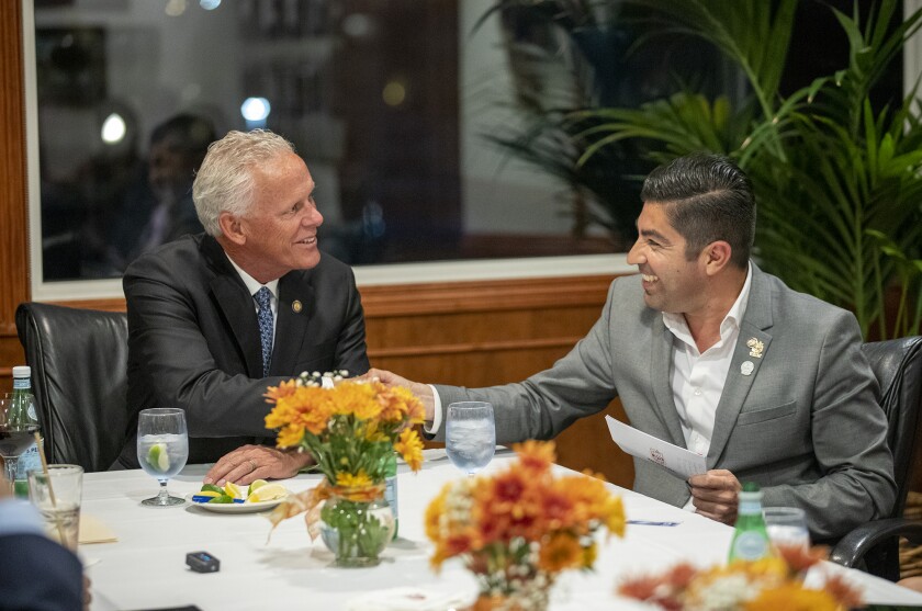 Mayor of Ensenada, Mexico, Armando Ayala right shakes hands with Newport Beach Mayor Brad Avery.