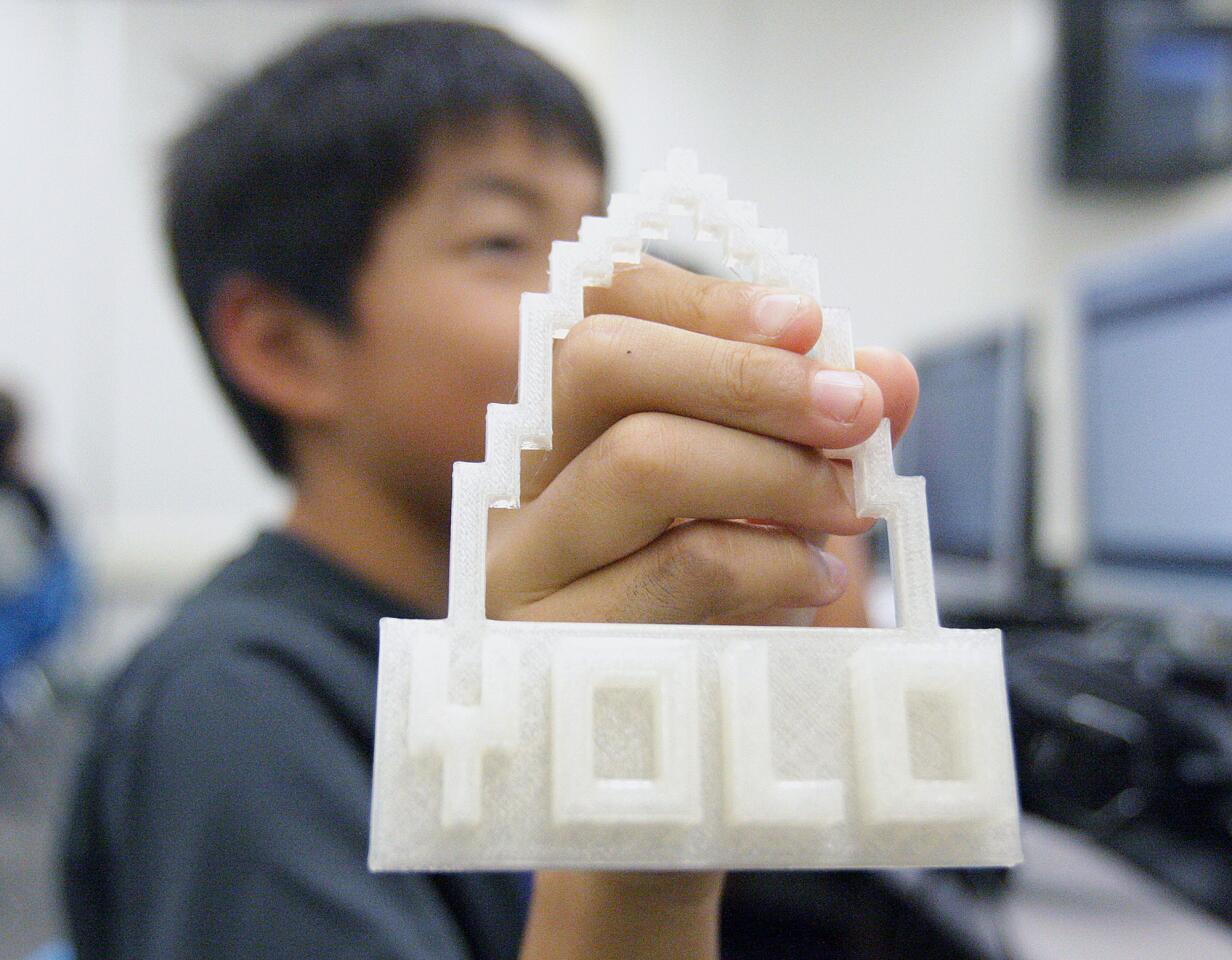 William Suh, 10, holds a 3D project he created in a 3-D printing class at Palm Crest Elementary School in La Ca-ada Flintridge on Monday, October 19, 2015. The popular 10-week 1-hour class meets once a week with the goal to give students experience in imagining in 3-D.