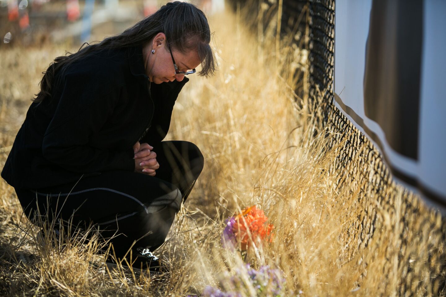 Robin Griffith of Portland pays her respects to the victims Saturday while in Roseburg.