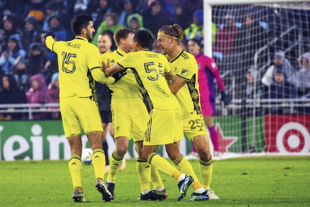 Nashville SC players celebrate after scoring early in the first half of an MLS soccer game against Minnesota United, Saturday, March 5, 2022, in Saint Paul, Minn. (AP Photo/Nicole Neri)