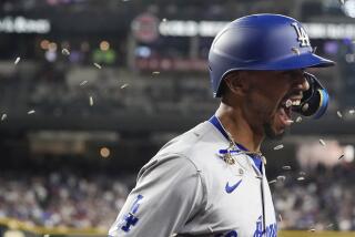 Los Angeles Dodgers' Mookie Betts gets sunflower seeds thrown at him as part of the celebration.