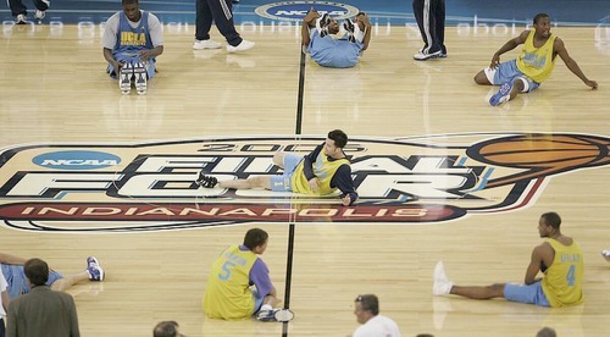 The UCLA Bruins men's basketball team led by guard Jordan Farmar, center, takes the court for practice.