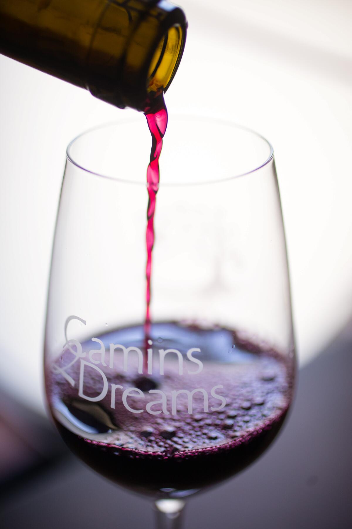 Camins 2 Dreams Carignan wine pours smoothly into a glass. 
