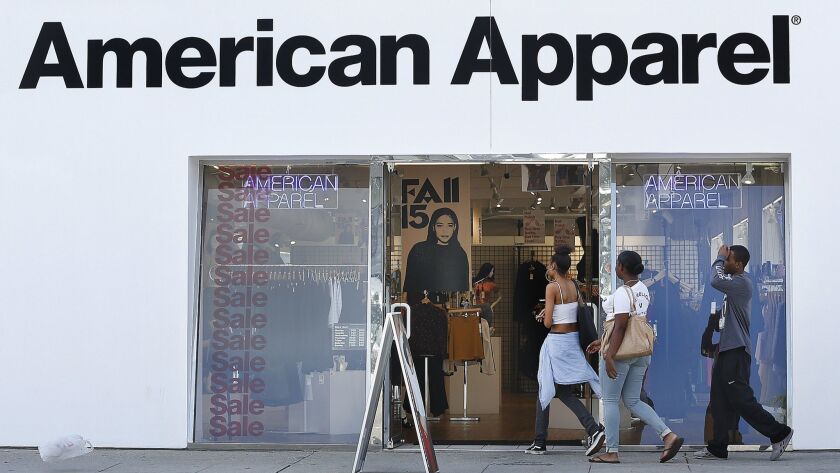 People enter an American Apparel store on Melrose Avenue in Los Angeles in October 2015.