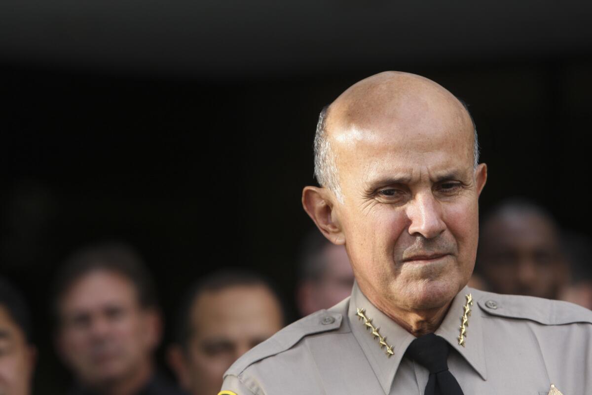 File Photo: Sheriff Lee Baca speaks during a toy drive outside of sheriff's headquarters building in Monterey Park on Monday, December 16, 2013. The drive was held by the Los Angeles Country Sheriff's Department and the Fred Jordan Mission. Baca announced on Tuesday, Jan. 7, 2014, that he would retire at the end of the month.