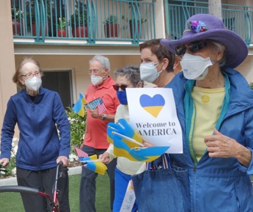 Residents of the White Sands retirement community greet a family who came to La Jolla after fleeing Ukraine.