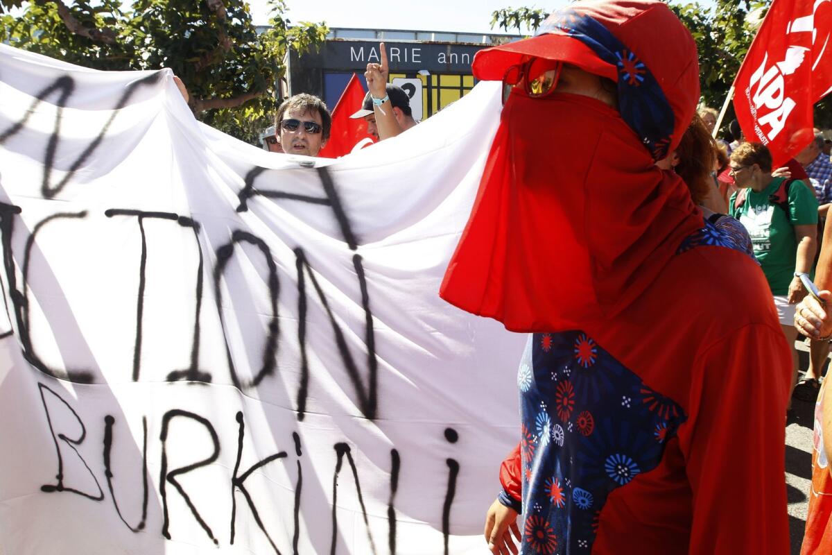 People gather in front of Port-Leucate city hall to protest the municipal ban on burkinis