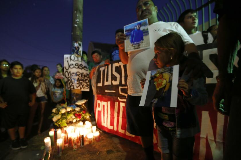 Boyle Heights residents gather near the intersection of Breed Street and Cesar Chavez Avenue on Wednesday night to protest the fatal officer-involved shooting of Jesse Moreno Romero.