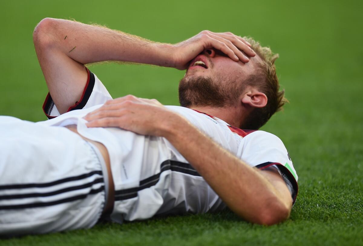 Germany's Christoph Kramer lies on the field after a collision during the World Cup final against Argentina. Kramer was allowed to go back into the game but was later subbed out.
