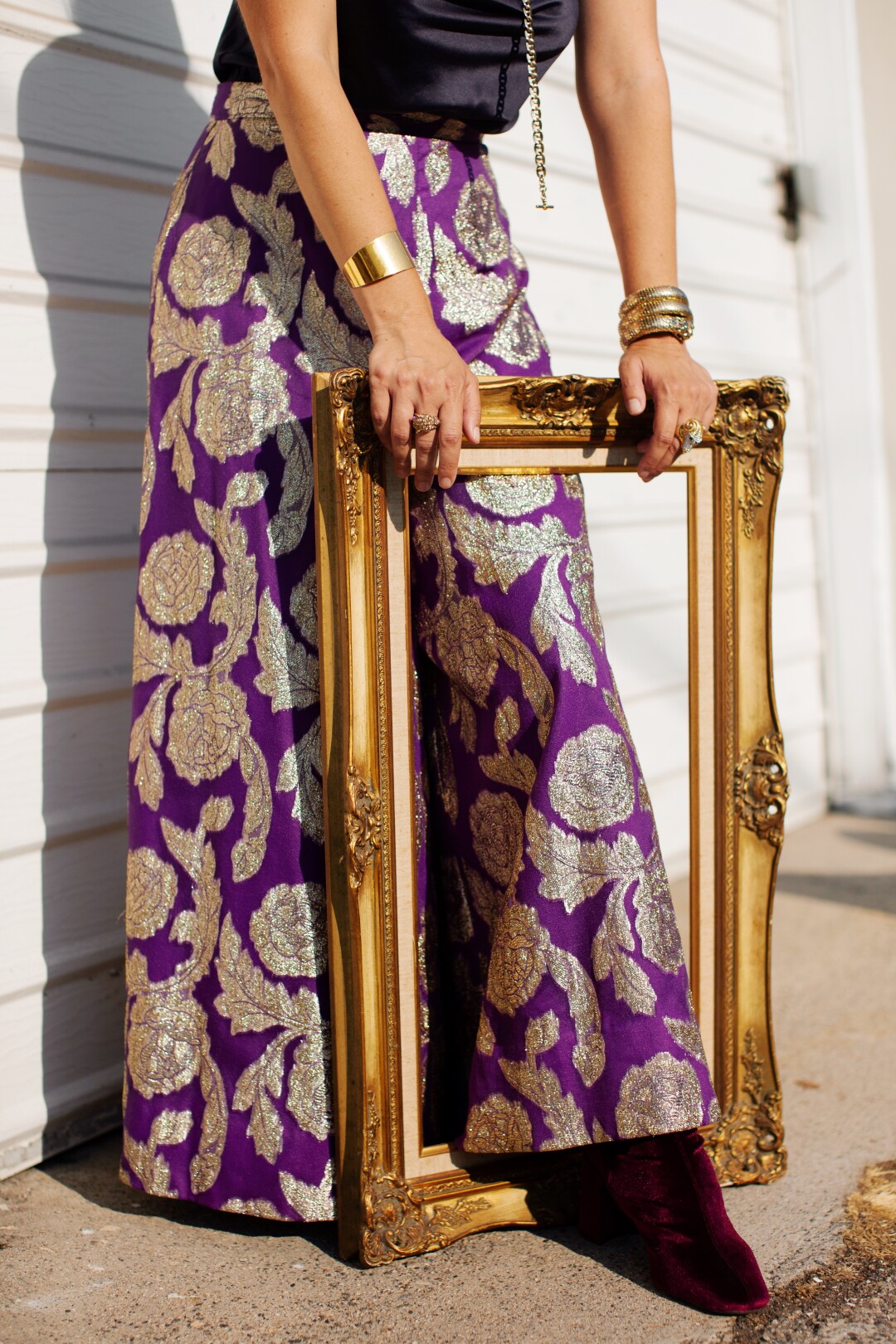 A woman holds a gold frame