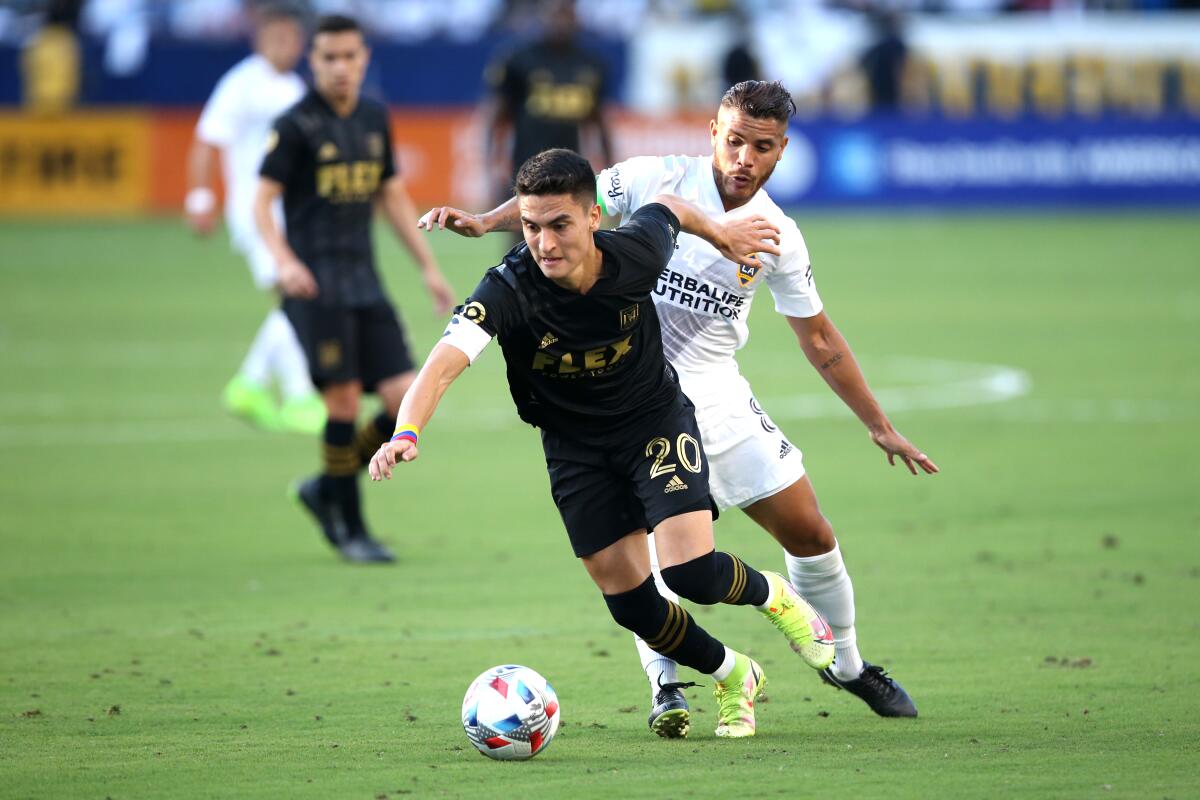 LAFC midfielder Eduard Atuesta controls the ball in front of Galaxy midfielder Jonathan dos Santos.