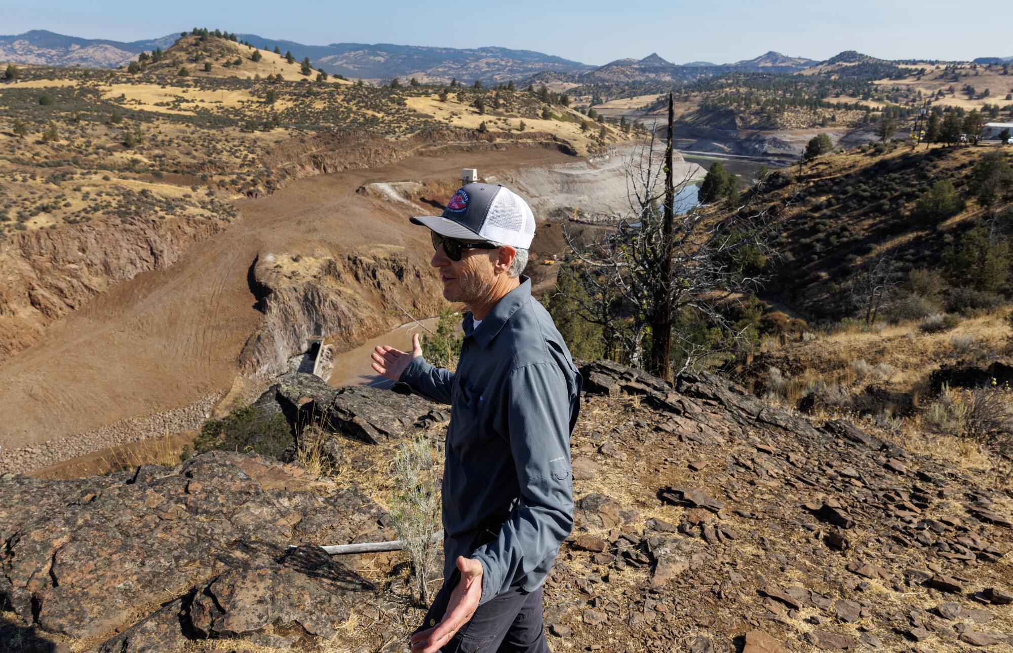 Mark Bransom, CEO of Klamath River Renewal Corp., speaks on a bluff overlooking the remnants of Iron Gate Dam.