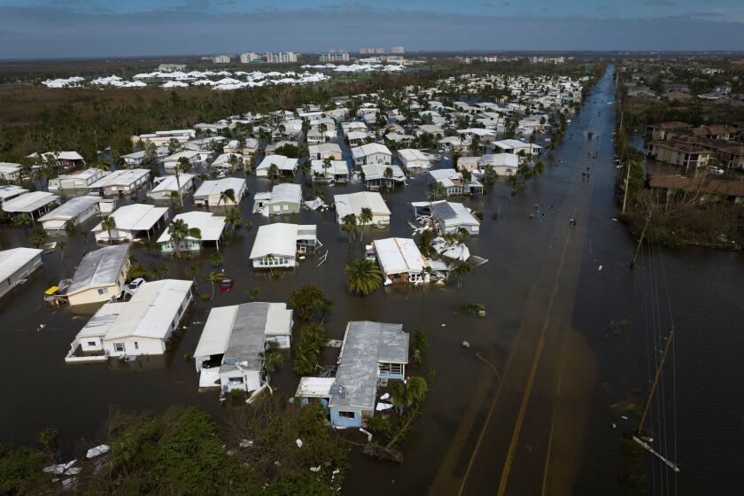 An aerial picture taken on September 29, 2022 shows a flooded neighborhood in the aftermath of Hurricane Ian in Fort Myers, Florida. - Hurricane Ian left much of coastal southwest Florida in darkness early on Thursday, bringing "catastrophic" flooding that left officials readying a huge emergency response to a storm of rare intensity. The National Hurricane Center said the eye of the "extremely dangerous" hurricane made landfall just after 3:00 pm (1900 GMT) on the barrier island of Cayo Costa, west of the city of Fort Myers. (Photo by Ricardo ARDUENGO / AFP) (Photo by RICARDO ARDUENGO/AFP via Getty Images)