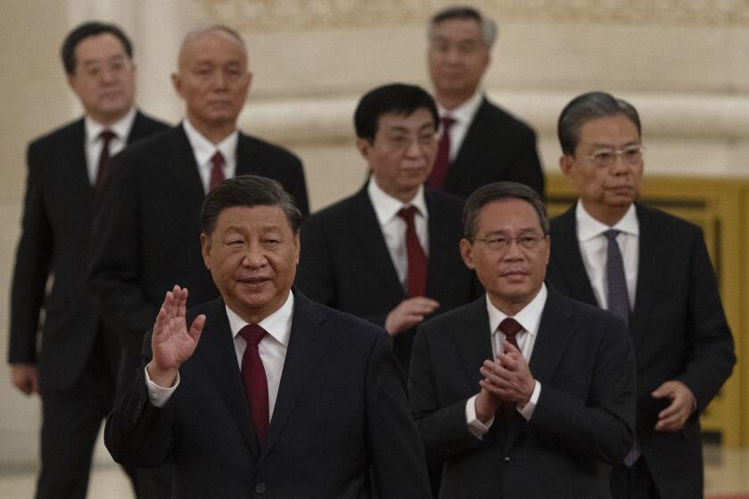 FILE - New members of the Politburo Standing Committee, front to back, President Xi Jinping, Li Qiang, Zhao Leji, Wang Huning, Cai Qi, Ding Xuexiang, and Li Xi arrive at the Great Hall of the People in Beijing on Oct. 23, 2022. The world faces the prospect of more tension with China over trade, security and human rights after Xi Jinping awarded himself a third five-year term on Oct. 23, 2022 as leader of the ruling Communist Party. (AP Photo/Ng Han Guan, File)