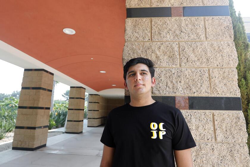 Arush Mehrotra stands at the Irvine Civic Center. An Irvine high school senior, Mehrotra is balancing distance learning and social justice work like the growing reach of the OC Justice Project across local high schools.