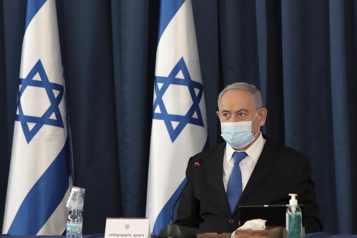 Israeli Prime Minister Benjamin Netanyahu wears a face mask at a Cabinet meeting in Jerusalem.