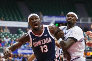 Gonzaga's Graham Ike and UCLA's Adem Bona battle for position while looking toward the basket