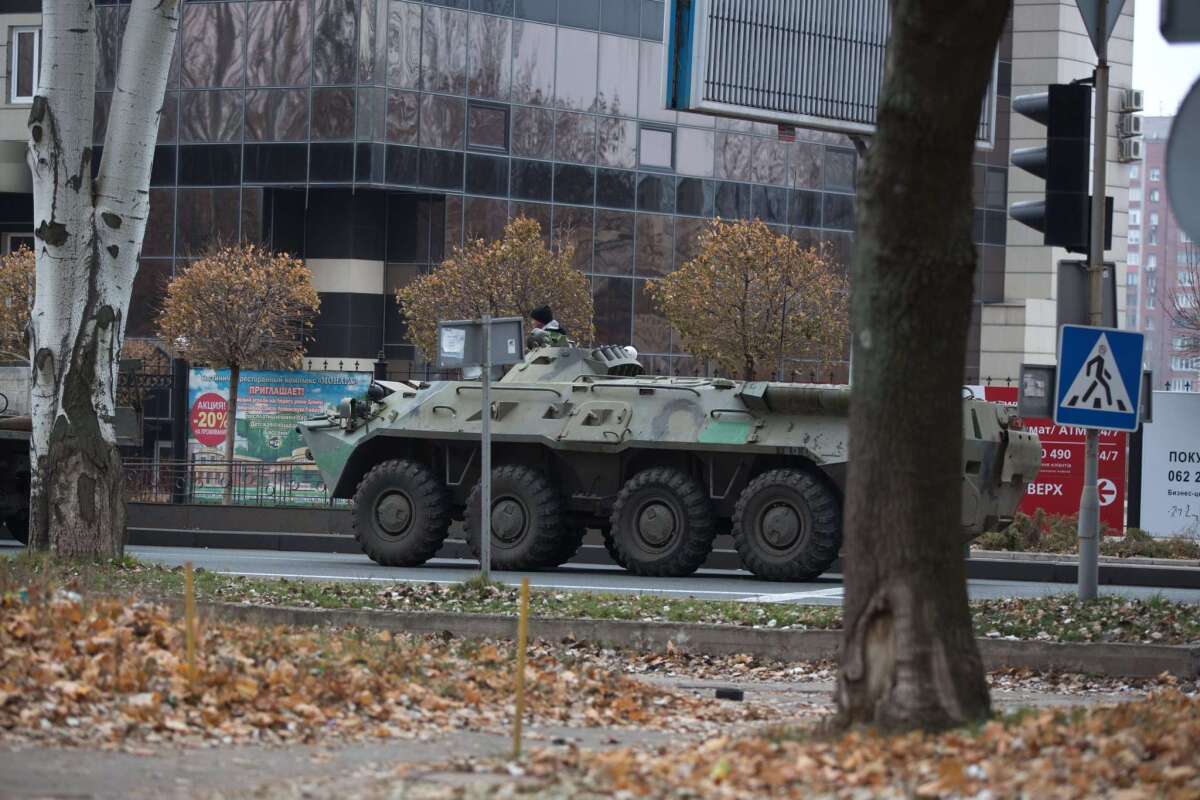 An armored personnel carrier rolls through Donetsk city on Wednesday, one of dozens of combat vehicles that NATO reports have flooded into the eastern Ukraine conflict area from Russia over the past few days.