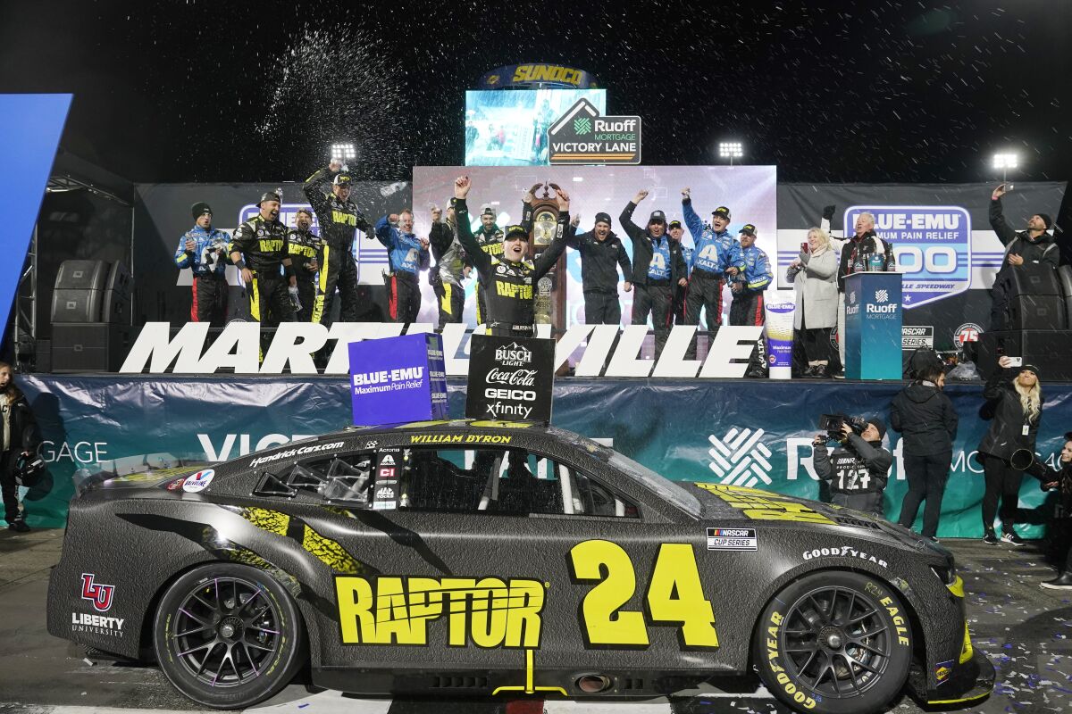 William Byron (24) celebrates after winning the NASCAR Cup Series auto race at Martinsville Speedway on Saturday, April 9, 2022, in Martinsville, Va. (AP Photo/Steve Helber)