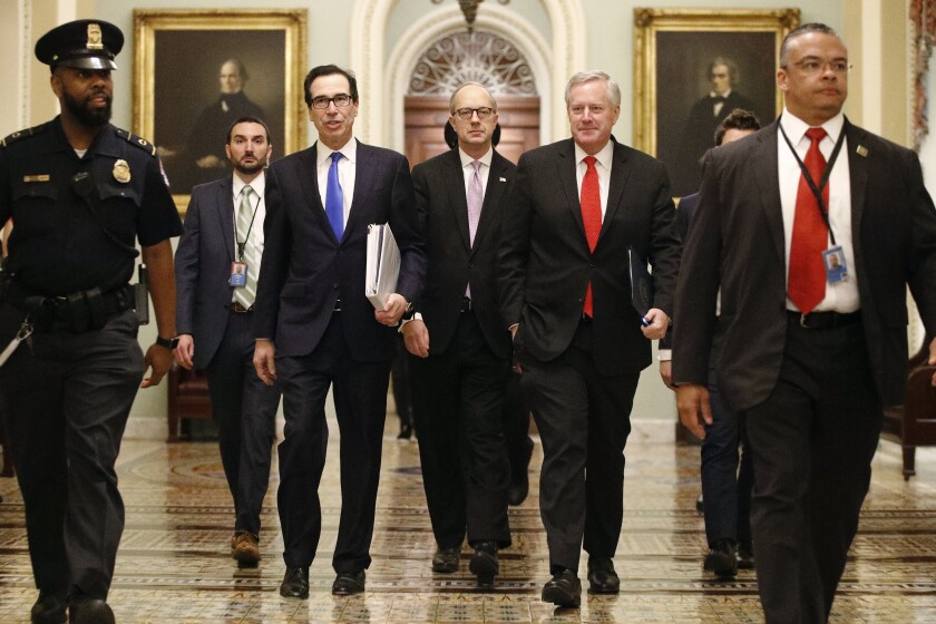 Treasury Secretary Steven Mnuchin, left, accompanied by White House Legislative Affairs Director Eric Ueland and acting White House chief of staff Mark Meadows, walks to the offices of Senate Majority Leader Mitch McConnell of Ky. on Capitol Hill in Washington, Tuesday, March 24, 2020. (AP Photo/Patrick Semansky)