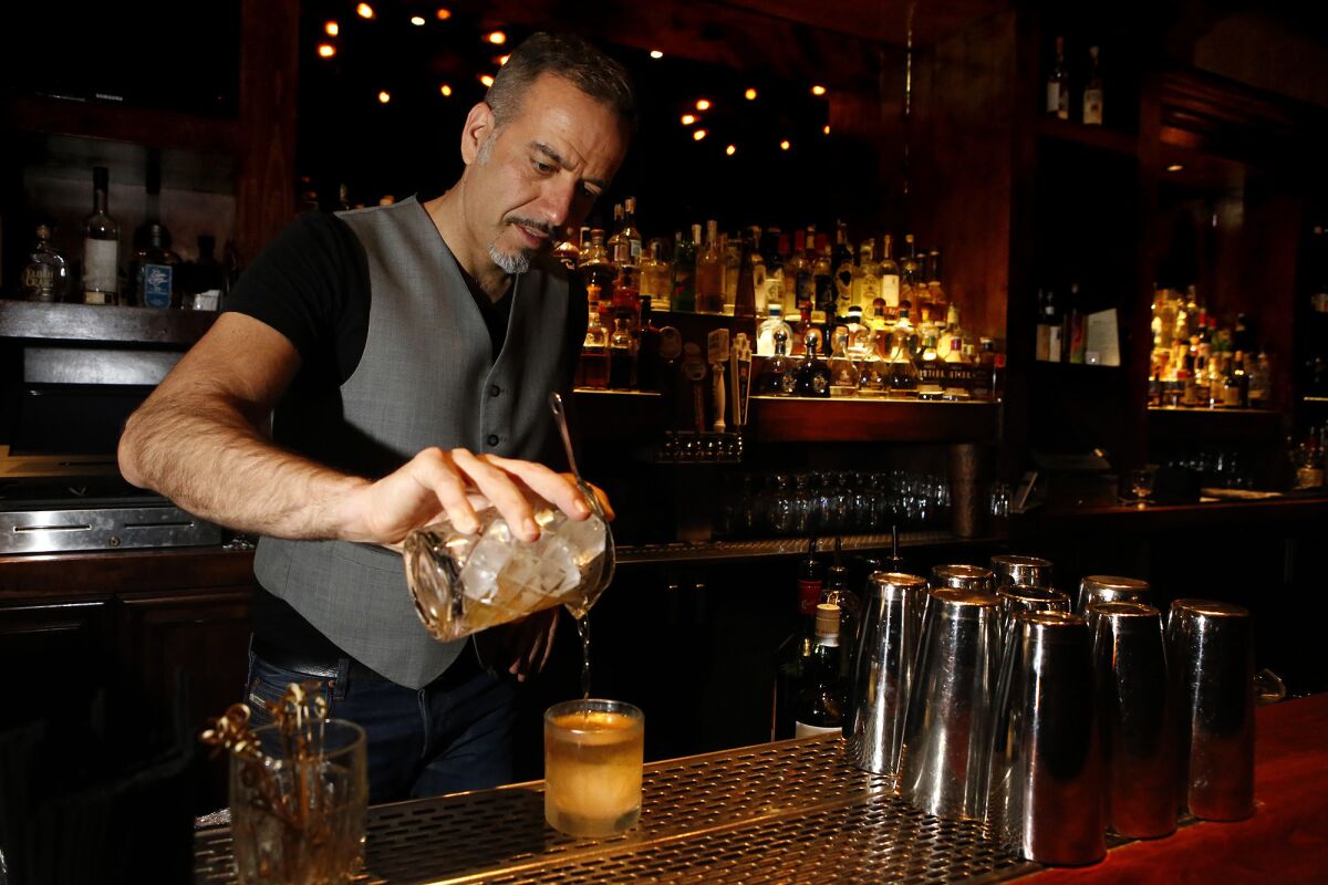 Vincenzo Marianella makes a Smoke of Scotland drink at the Copa d'Oro bar in Santa Monica on April 23, 2015.