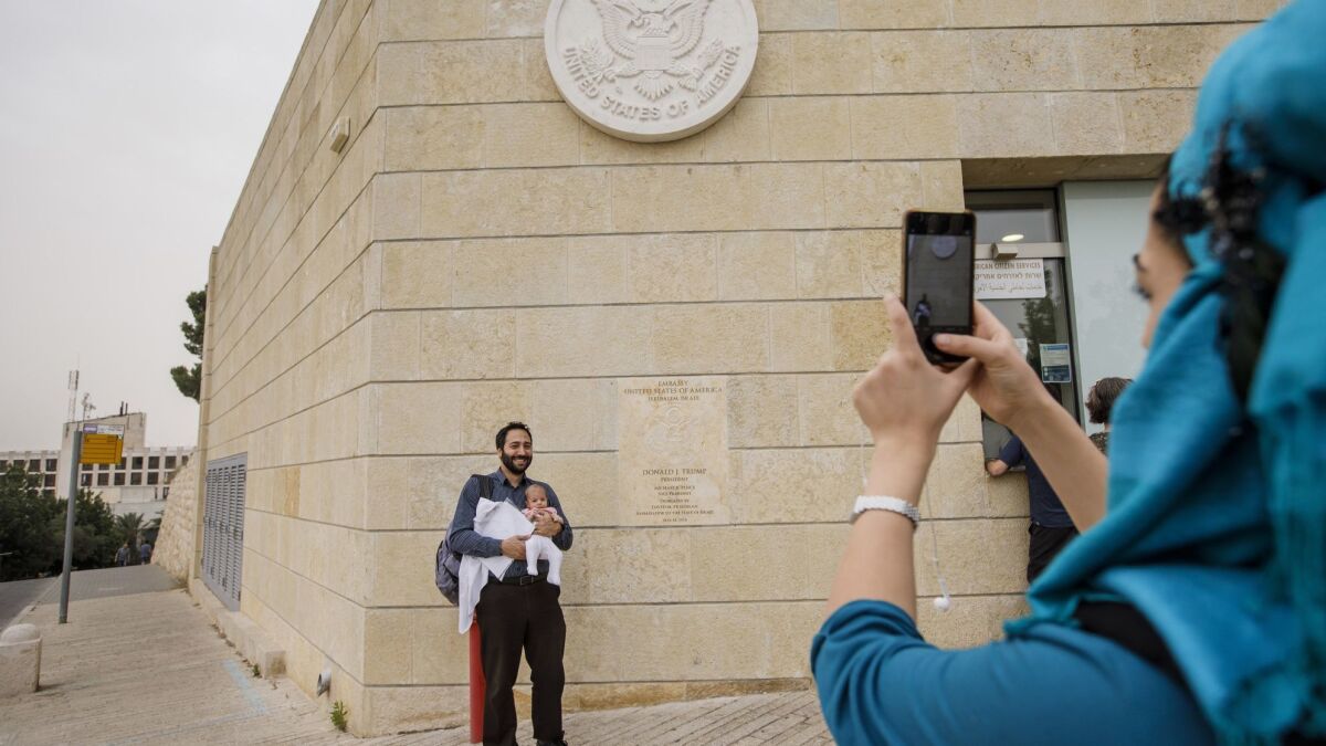 Ramin Melamed and his daughter Ayalah, 2 months old, in front of the U.S. Embassy in Jerusalem after getting her citizenship paperwork done in May.