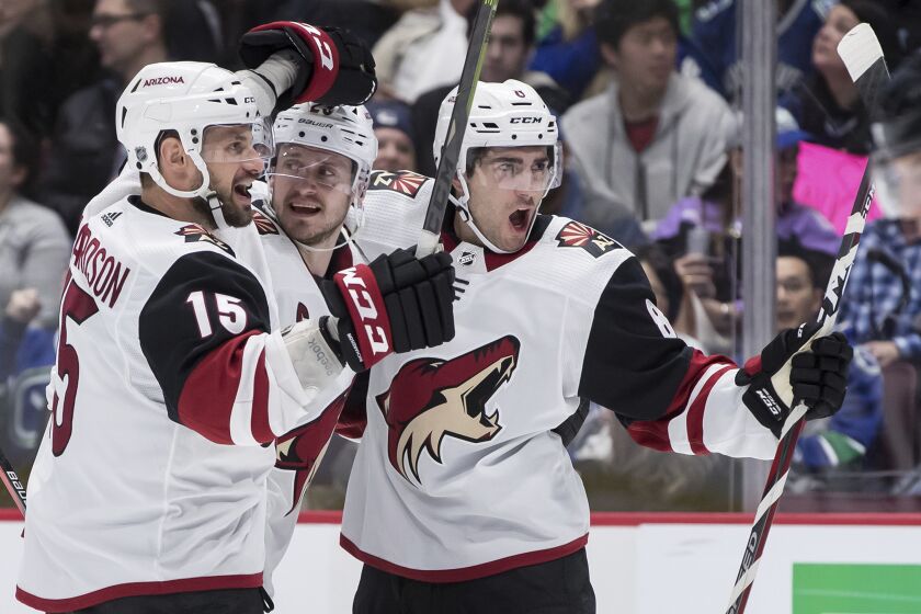 Arizona Coyotes' Brad Richardson; Oliver Ekman-Larsson, of Sweden; and Nick Schmaltz, from left, celebrate Schmaltz's goal against the Vancouver Canucks during the third period of an NHL hockey game Wednesday, March 4, 2020, in Vancouver, British Columbia. (Darryl Dyck/The Canadian Press via AP)