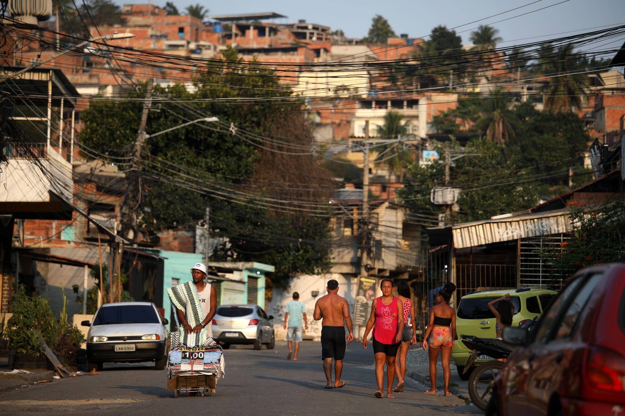 People walk in a neighborhood.