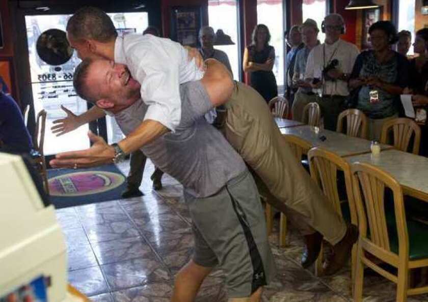 President Obama is picked up by Scott Van Duzer, owner of Big Apple Pizza, during a visit to the restaurant in Fort Pierce, Fla.