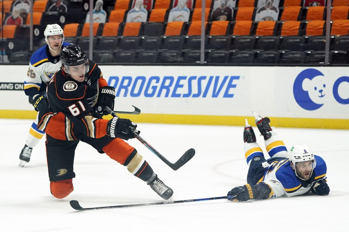 Ducks right wing Troy Terry takes a shot on goal as St. Louis Blues defenseman Marco Scandella defends.