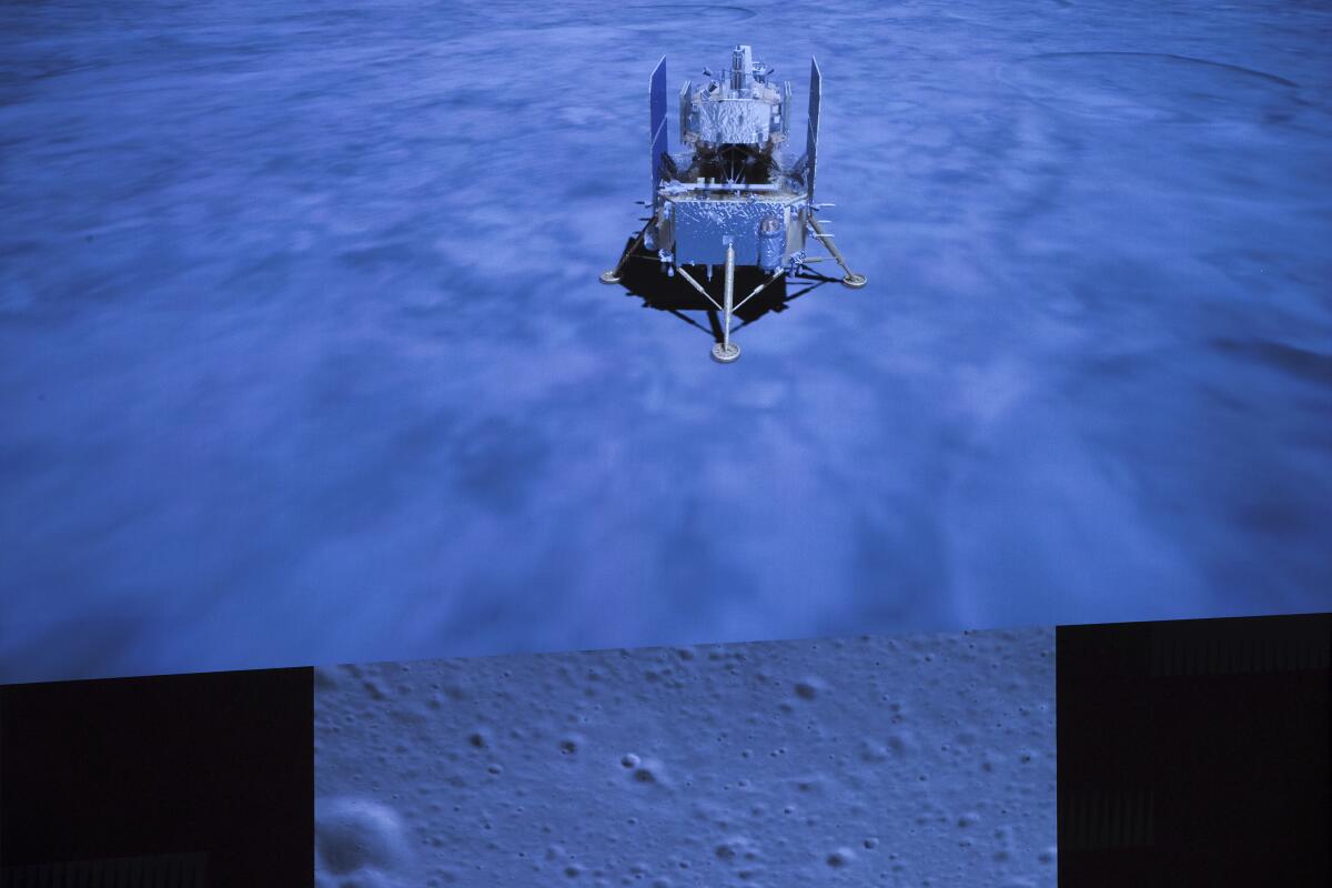 A screen shows images of China's Chang'e 5 spacecraft and the moon's surface.