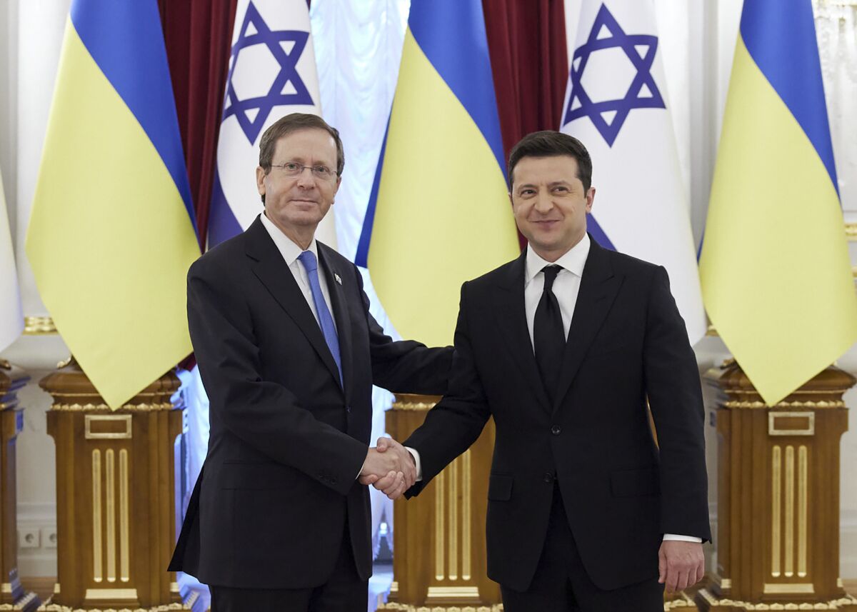 Israeli President Isaac Herzog, left, and Ukrainian President Volodymyr Zelenskyy shake hands in Kyiv, Ukraine