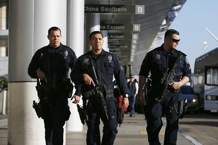 LAX airport police officers with automatic weapons patrol near the Tom Bradley International Terminal on March 22, 2016. A terrorist attack in Brussels has put law enforcement on high alert in Los Angeles despite no specific threats.
