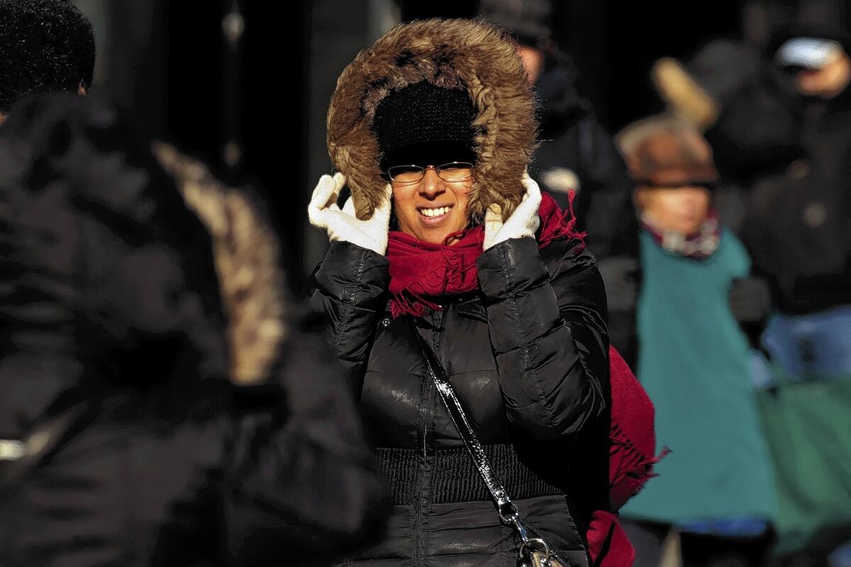 Pedestrians brave the cold in Brooklyn. New York City reached a record low of 4 degrees.