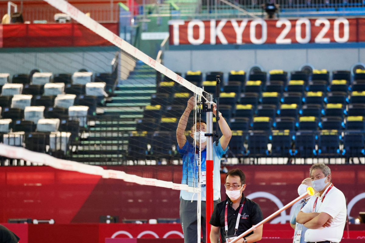 TOKYO, JAPAN - JULY 19: Officials prepare a volleyball net at the Ariake Arena.