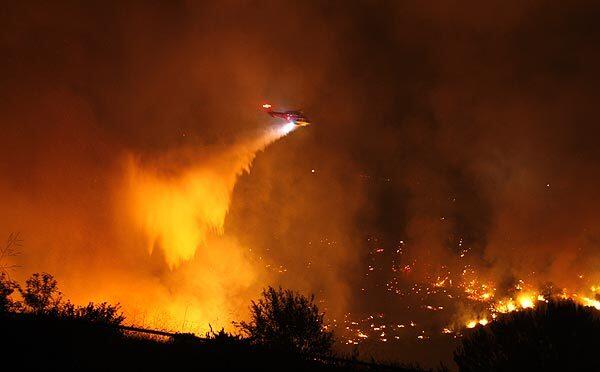 A helicopter makes a water drop in Rancho Palos Verdes.