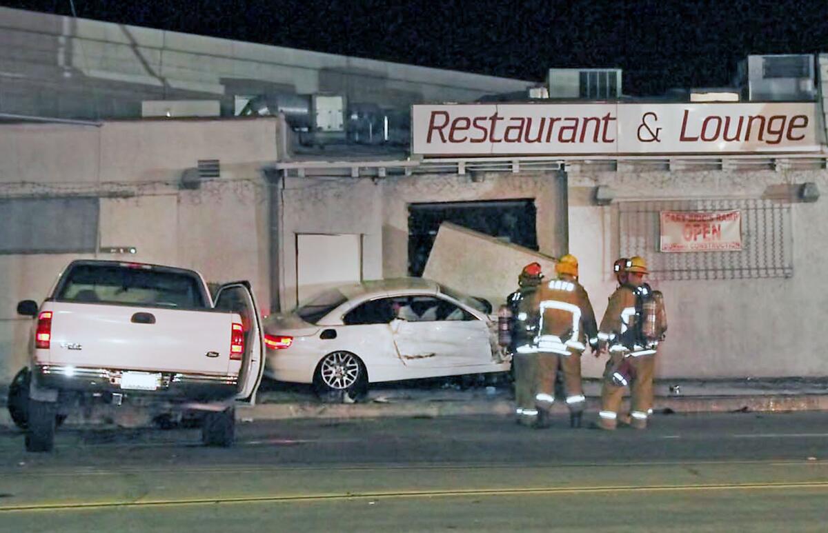 Firefighters work the scene of a traffic collision in Sun Valley early Tuesday damaged The Ramp, a restaurant owned by Burbank city councilman Gary Bric.