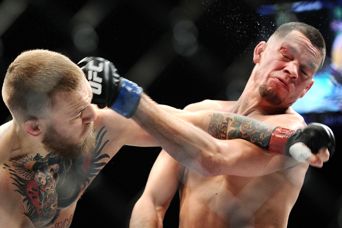 Conor McGregor, left, and Nate Diaz exchange punches during their welterweight fight at UFC 196 on March 5.