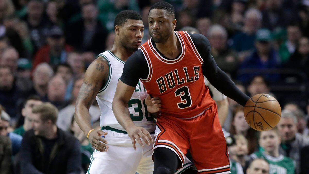 Boston Celtics guard Marcus Smart, left, tries to block Chicago Bulls guard Dwyane Wade, right, in the fourth quarter on March 12.