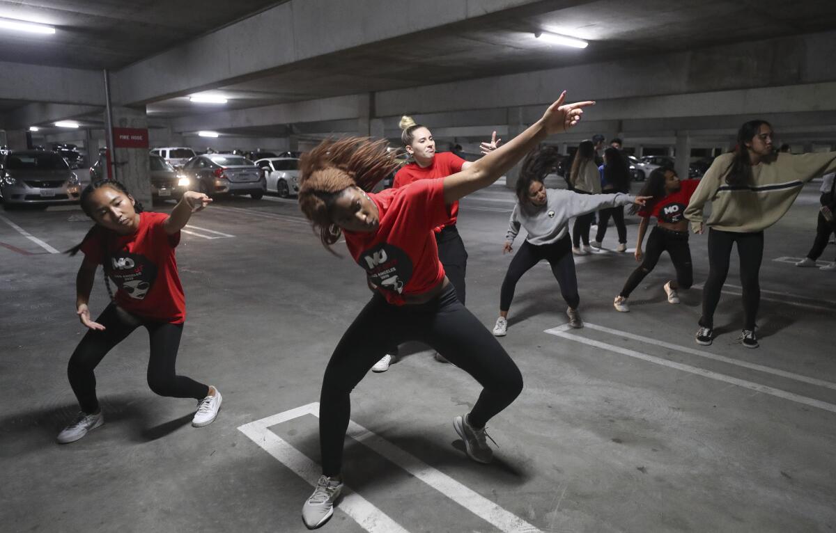 San Diego State student Maria Sulaiman, 19, front, leads her group as they practice their hip-hop dance that she choreographed before performing in the end of the year choreography project put on by the SDSU Vietnamese Student Organization Modern, a collegiate hip-hop dance troupe, in a parking garage on the SDSU campus on Thursday, December 5, 2019 in San Diego, California.