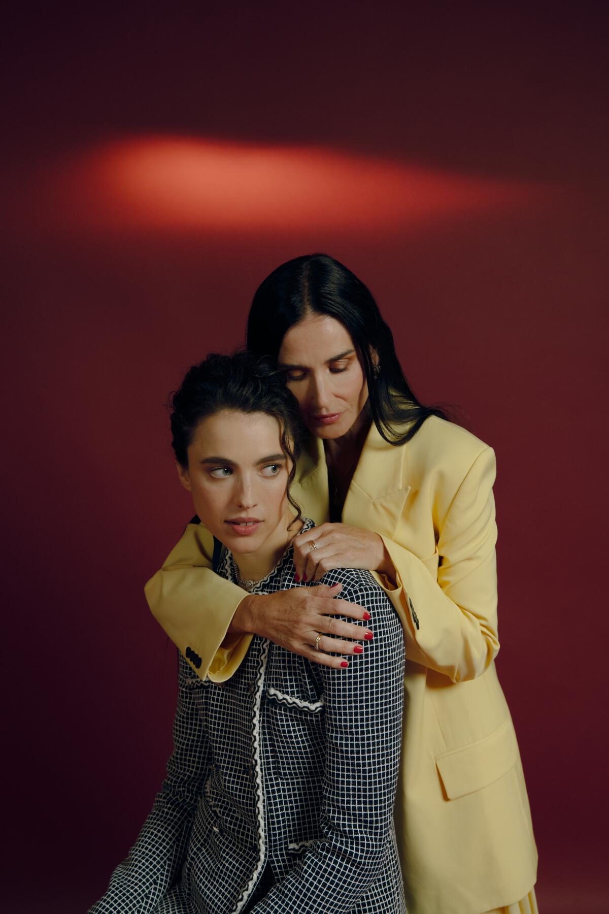 Two actors embrace during a photo shoot.