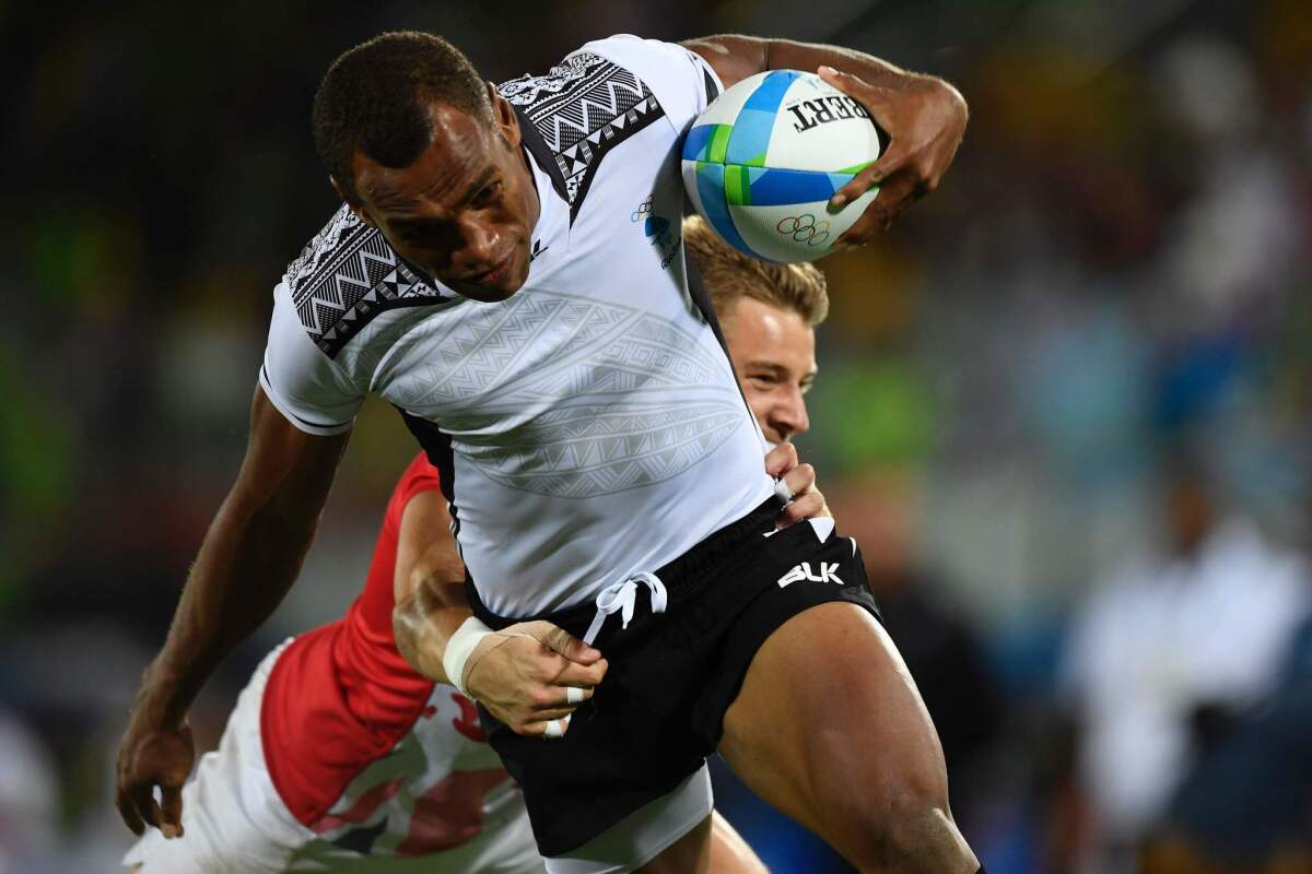 Fiji's Osea Kolinisau scores a try in the mens rugby sevens gold medal match between Fiji and Britain during the Rio 2016 Olympic Games at Deodoro Stadium in Rio de Janeiro on August 11, 2016. / AFP PHOTO / John MACDOUGALLJOHN MACDOUGALL/AFP/Getty Images ** OUTS - ELSENT, FPG, CM - OUTS * NM, PH, VA if sourced by CT, LA or MoD **