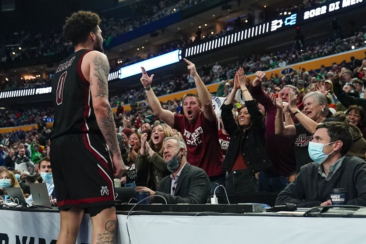 New Mexico State guard Teddy Allen (0) reacts to fans after scoring against Connecticut late in the second half of a college basketball game in the first round of the NCAA men's tournament Thursday, March 17, 2022, in Buffalo, N.Y. (AP Photo/Frank Franklin II)
