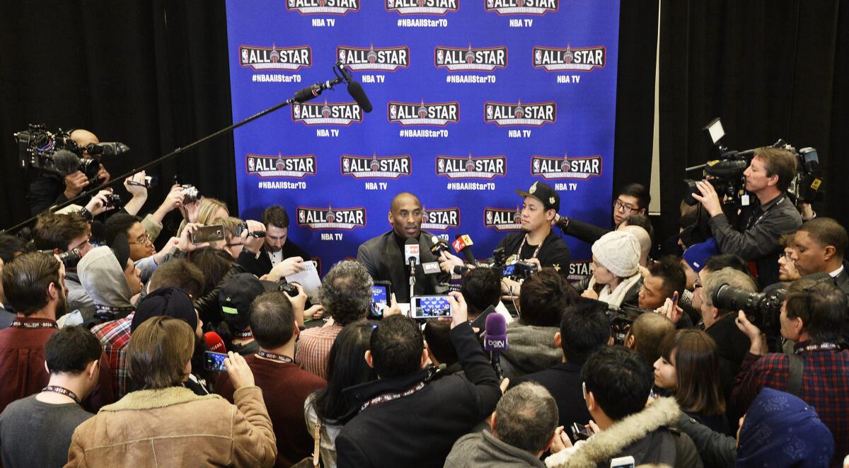 Lakers All-Star Kobe Bryant, center, talks to reporters during a news conference leading up to the NBA All-Star game in Toronto.