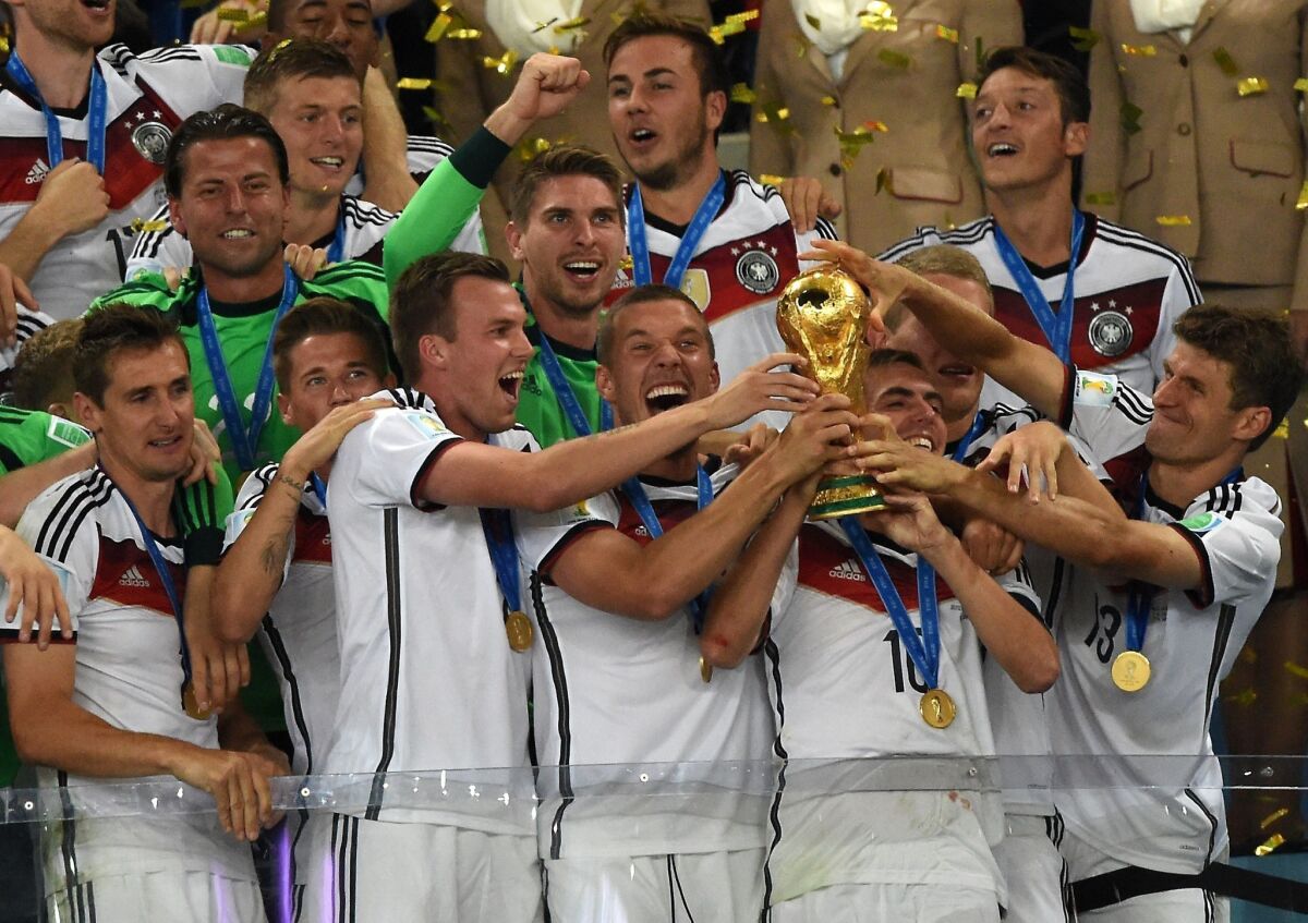 Germany players celebrate with the World Cup trophy following their 1-0 victory over Argentina in the World Cup final.