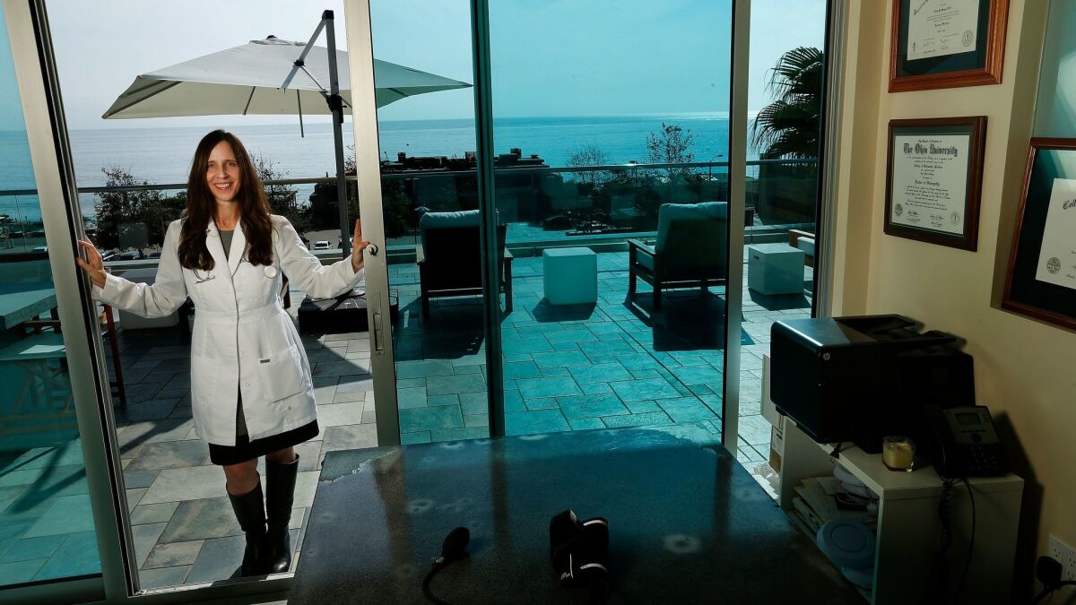 Dr. LIsa Benya of Cure is photographed at the entrance to her office in Malibu that has a deck outside overlooking the Pacific Ocean.