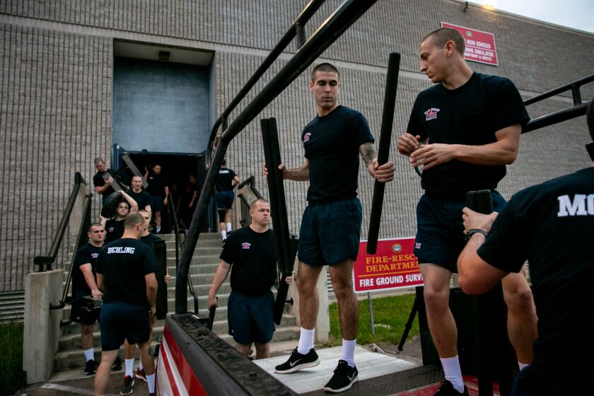Recruits do a morning workout as part of the San Diego Fire-Rescue Department's 87th Academy at the department's training facility on March 27, 2019 in San Diego, California.